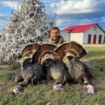 man with 3 turkeys