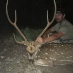 man with spotted deer night hunt