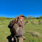 man with turkey over the shoulder